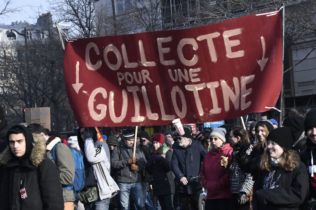 speech Protesters hold a banner reading ''Fund-raising for a guillotine'