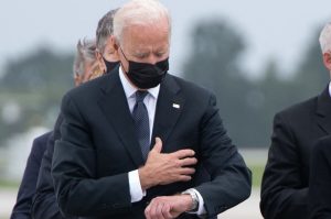 grief President Joe Biden looks down at his watch (Getty Images)