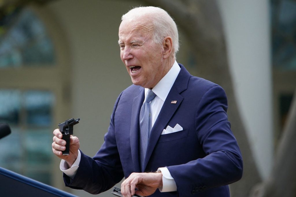 US President Joe Biden holds a 9mm pistol build kit (Getty Images)