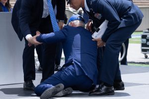 US President Joe Biden is helped up after falling during the graduation ceremony at the United States Air Force Academy (Getty Images)